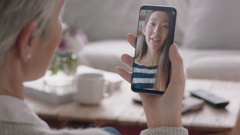 Mujer-Madura-Teniendo-Video-Chat-Usando-Un-Teléfono-Inteligente-Conversando-Con-Su-Hija-En-La-Pantalla-Del-Teléfono-Móvil-Sonriendo-Disfrutando-De-Una-Conversación-Compartiendo-Estilo-De-Vida-Con-La-Familia-4k