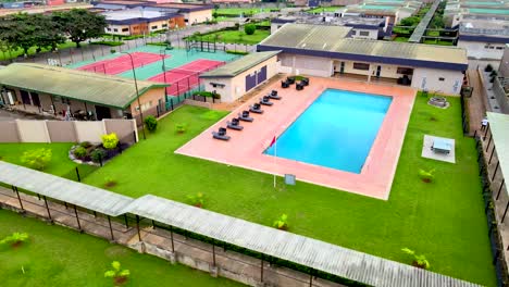 swimming pool in a resort with a green lawn