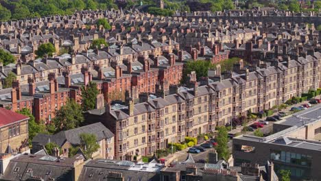 drone footage revealing the uniform architecture and layout of houses in a traditional edinburgh neighborhood, highlighting urban charm and harmony