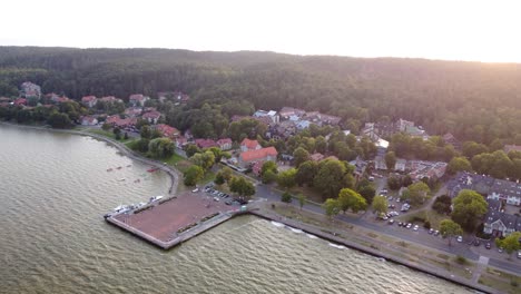 AERIAL-Ascending-Shot-of-the-Resort-Town-Juodkrante-and-its-Harbor-in-Curonian-Spit-National-Park,-Lithuania