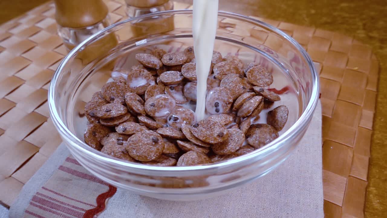 아침에 우유와 함께 맛있는 아침 식사를 위해 그 ⁇ 한 초콜릿 플레크를 그 ⁇ 에 넣습니다. 회전 추적  ⁇ 으로 느린 동작.