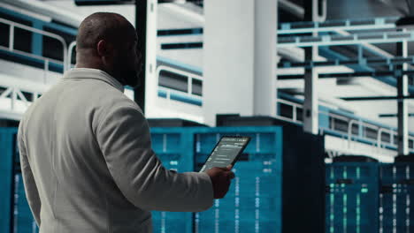 vertical video data center technician using laptop to manage software updates
