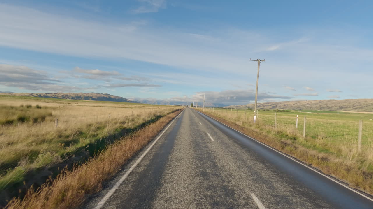 viaje panorámico en una carretera de campo recta en el sur de otago, nueva zelanda