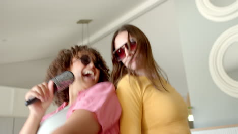 dancing at home, diverse women friends enjoying music and having fun together