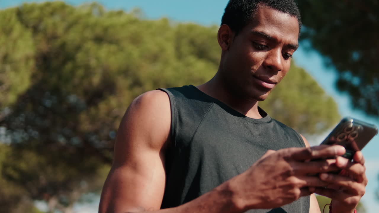 Athlete Checks Fitness App on Phone After Workout
