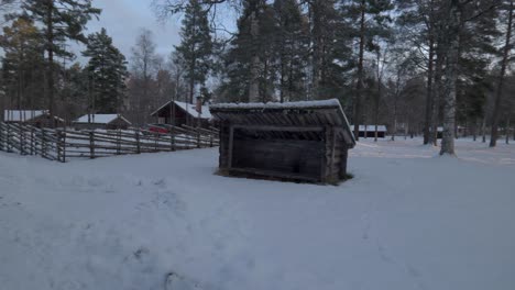 wind shelter and cottages in snowy landscape, scandinavia, pan