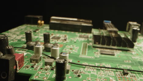 Beautiful macro dolly in of a circuit board in a dark studio