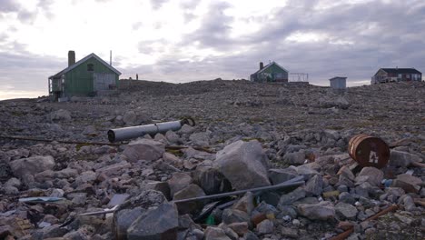 small settlement with couple of houses on coast of greenland, panorama