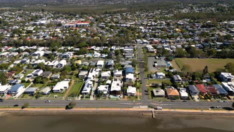 Aerial-view-moving-left-to-right-of-Sandgate-and-Brighton-waterfront-on-a-sunny-day,-Brisbane,-Queensland,-Australia