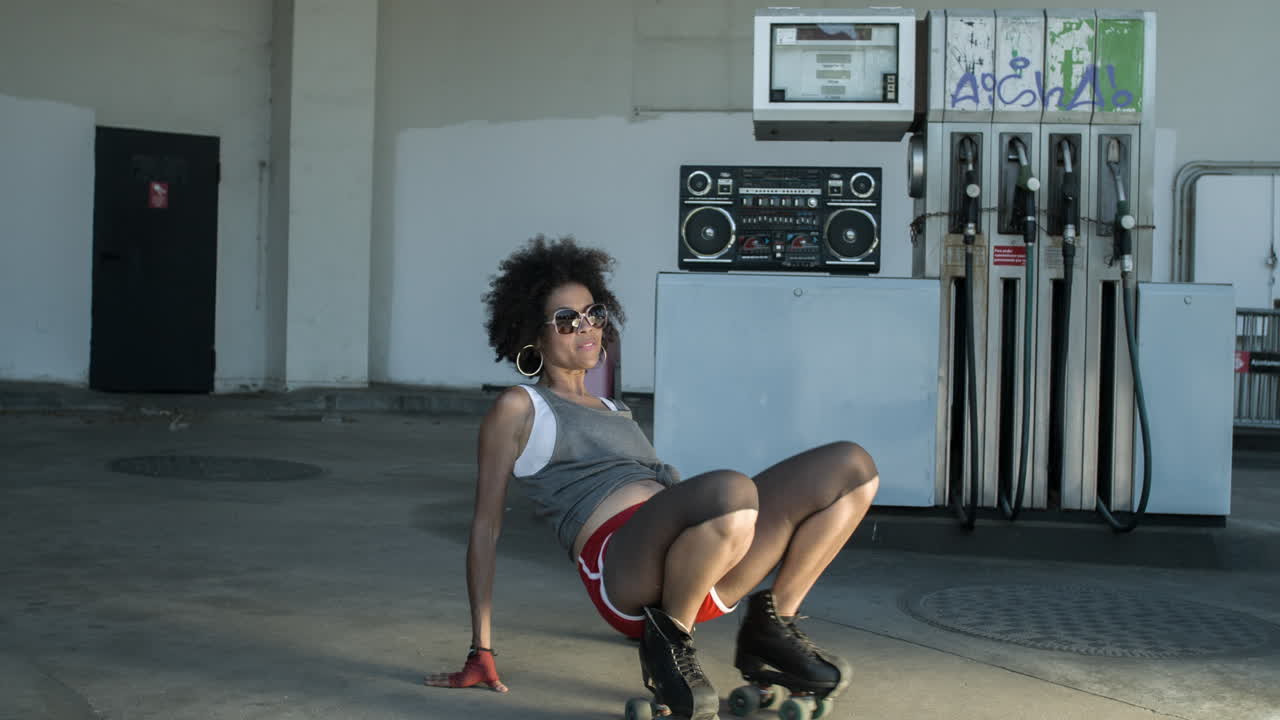 cool roller skating woman dances and skates outside in an urban setting