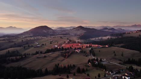 aerial panoramic of remote village on a hill in transylvania at sunset