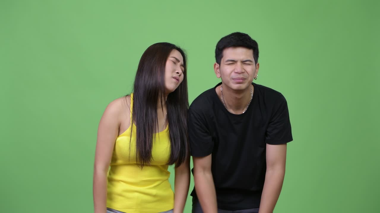 Young Asian couple looking frustrated together