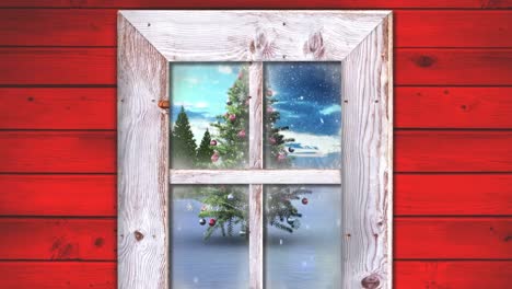 wooden window frame against snow falling over christmas tree on winter landscape