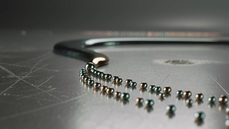 Pulling curved pendant by magnetic attraction, dragging beads across scratched bench