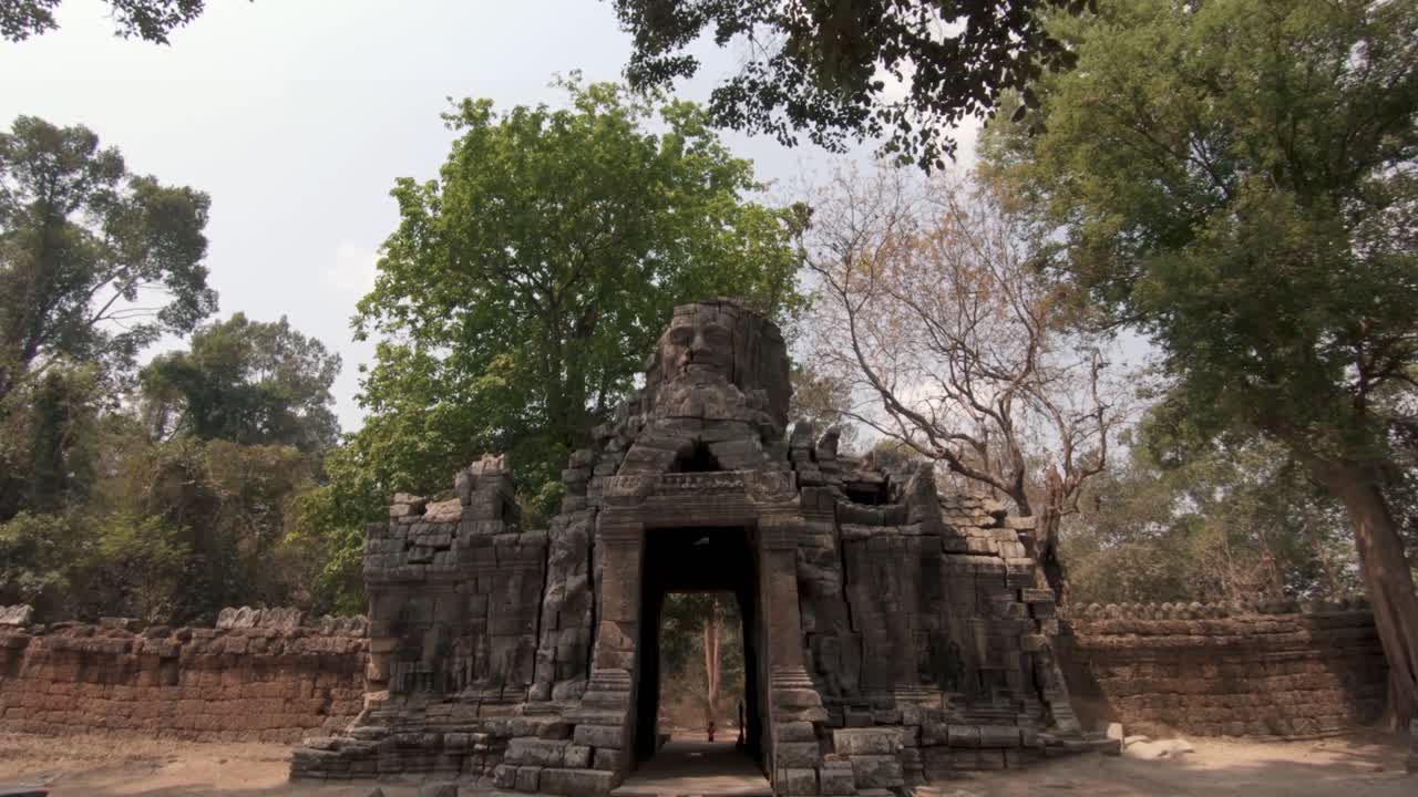 Ruins and stone carvings of Angkor Wat temple complex, Cambodia. Dolly in shot