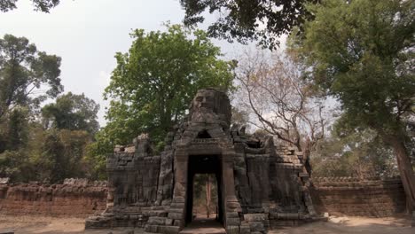 ruins and stone carvings of angkor wat temple complex, cambodia. dolly in shot