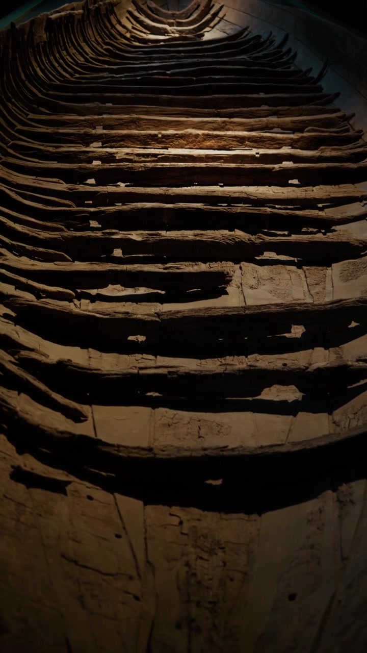 Narrow view inside wooden shipwreck with layered planks