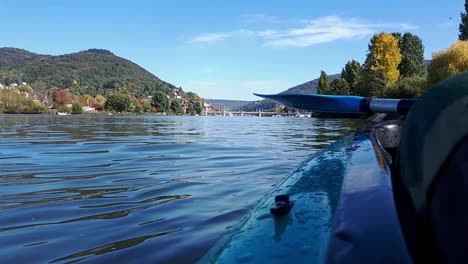 view of heidelberg hills and city from canoe on neckar river, germany europe