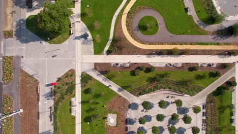 aerial ascending shot of park area with plants and road in gdynia city during sunny day