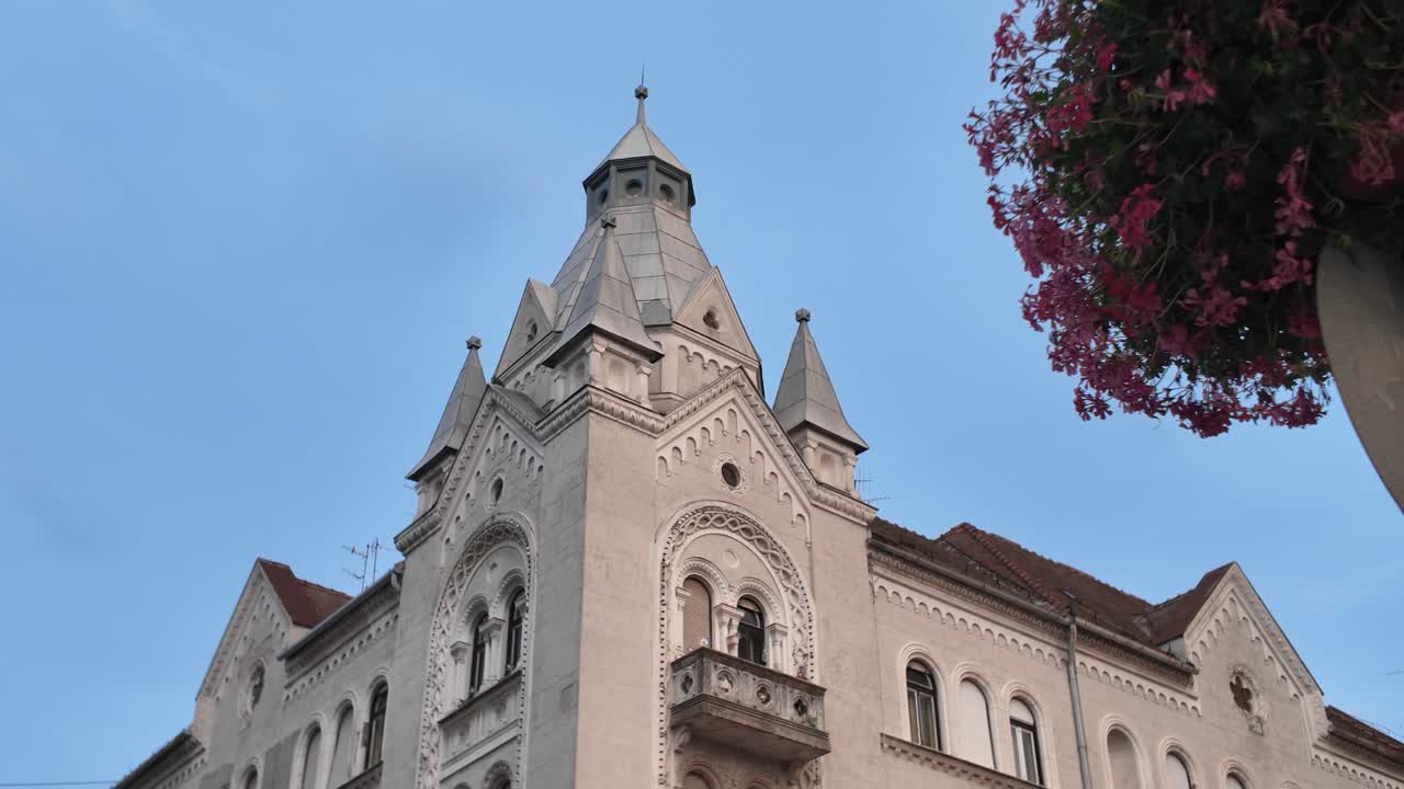Exterior footage of a historic building in Szeged, Hungary, highlighting architectural details and heritage features
