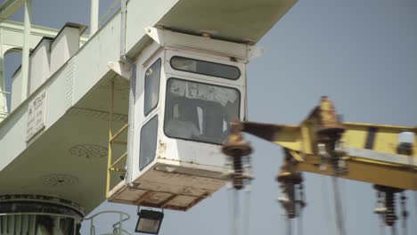 shipyard. a worker operates a large crane