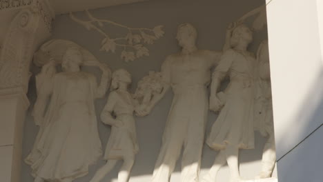 depiction of family in a high relief form, created in socialist realism style