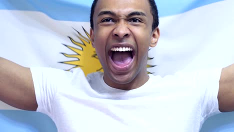 argentinian fan celebrates holding the flag of argentina in slow motion