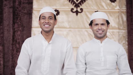 two happy indian muslim men smiling at the camera