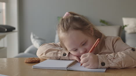 schoolgirl with down syndrome doing homework