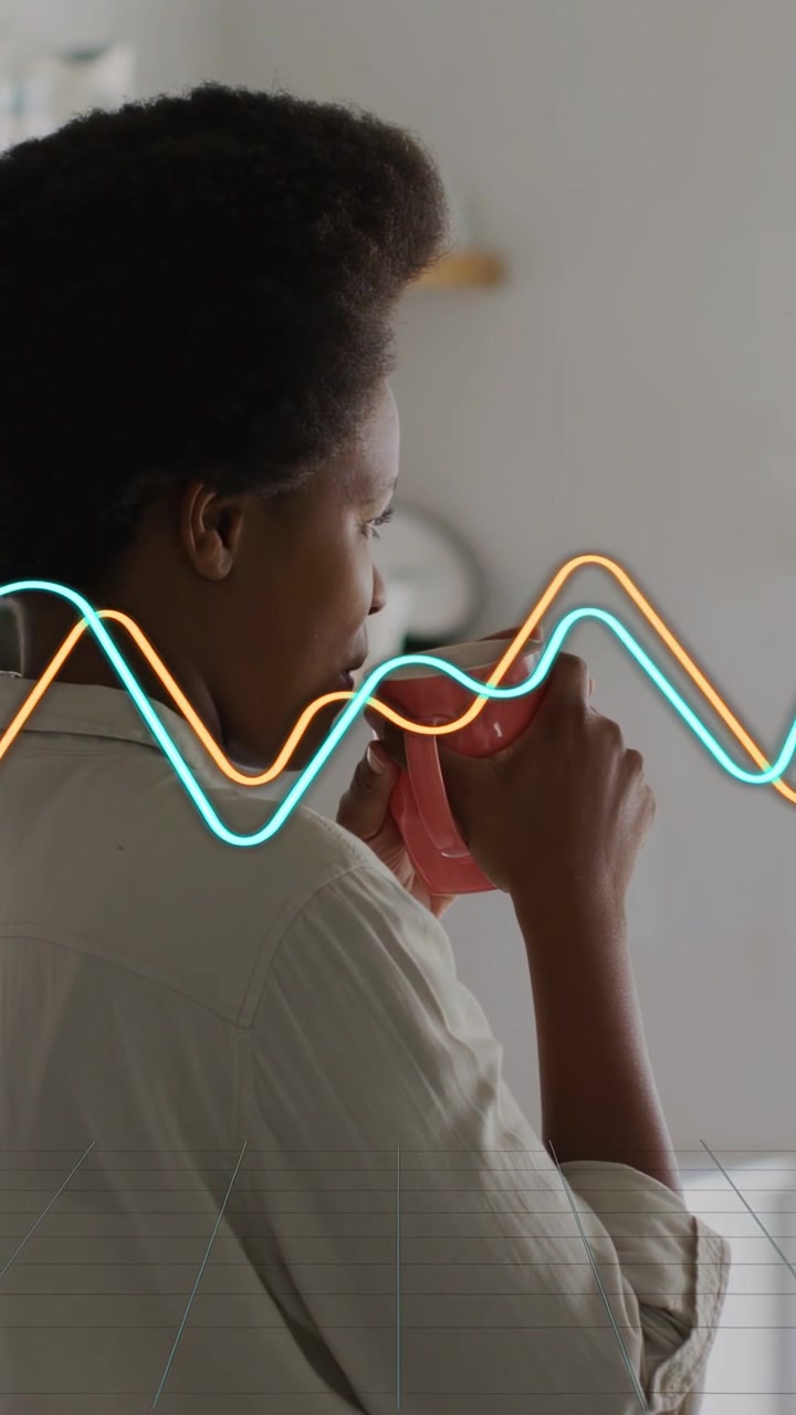 Vertical video: Woman lifting pink mug at home as waves crossing mug sniffing aroma sipping coffee
