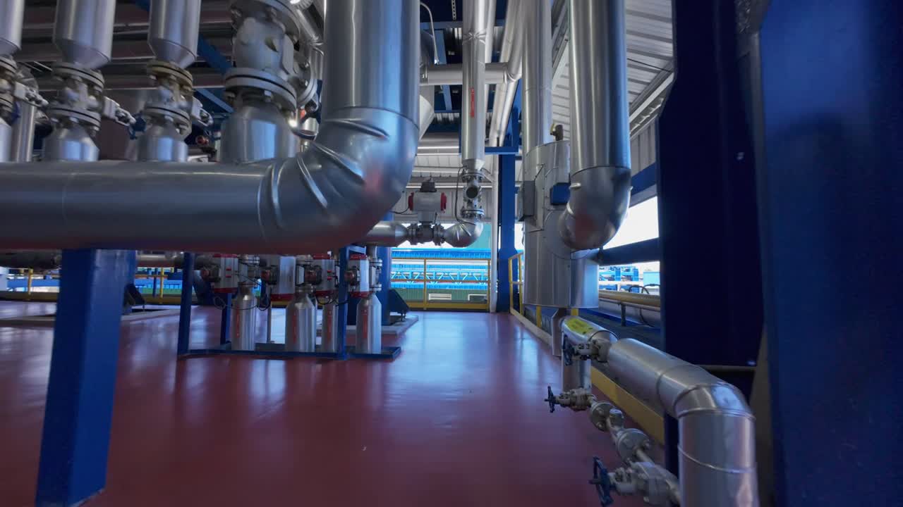 Pov flight between pipelines, track and storage of factory building. La ...