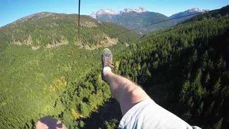 pov feet flying over a forest in whistler canada in slow motion