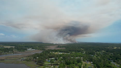 wide drone shot of a forest fire, panning shot