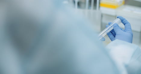 Female-Scientist-Doing-Experiment-In-Laboratory-Scientist-Holding-Test-Tube-In-Hands-3