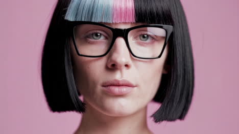 woman with pink and blue hair and glasses