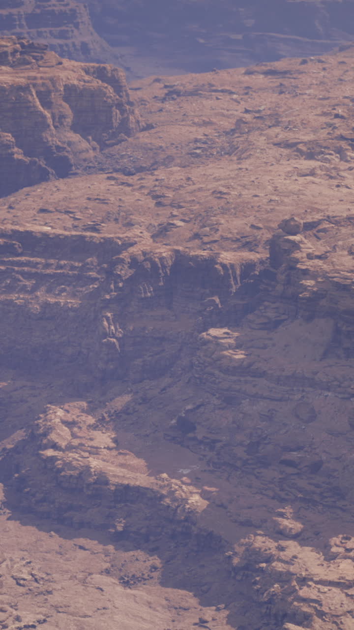 Panoramic view of rocky canyon landscape under blue sky during daylight