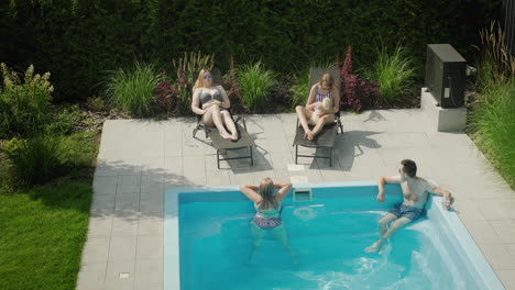 Family-with-dog-relaxing-by-the-pool