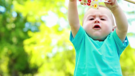 Cute-baby-boy-playing-with-a-pinwheel