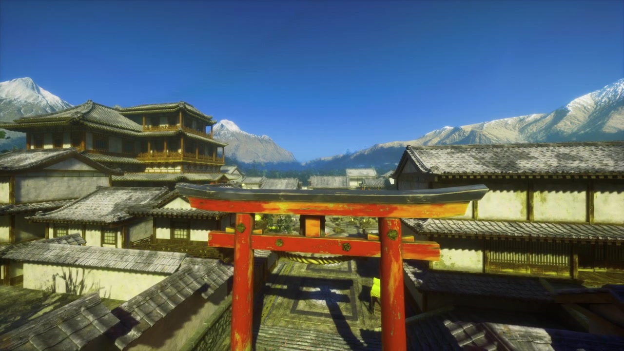 Torii illuminato dal sole tra tetti tranquilli e lontane montagne innevate