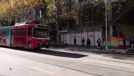 colorful tram moving through city street