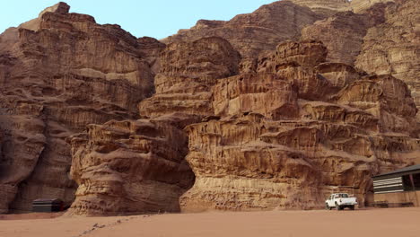 desert landscape with rock formations and off-road vehicle