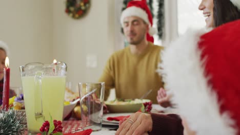 focused caucasian family praying together before christmas dinner