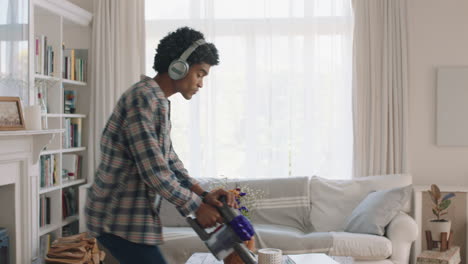 happy-young-man-dancing-at-home-using-vacuum-cleaner-celebrating-success-listening-to-music-wearing-headphones-having-fun-dance-in-living-room-on-weekend