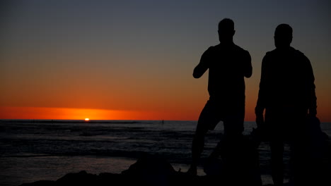 Silueta-De-Personas-Viendo-La-Puesta-De-Sol