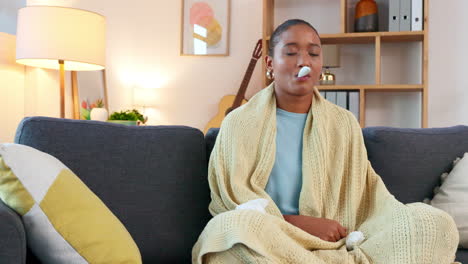 sick woman measuring her temperature using