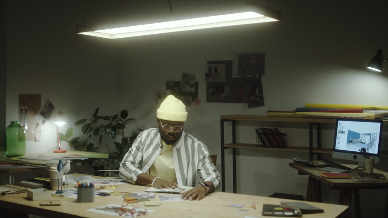 Man working on a design project in his studio at night
