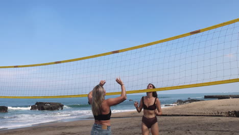 girls playing beach volleyball.