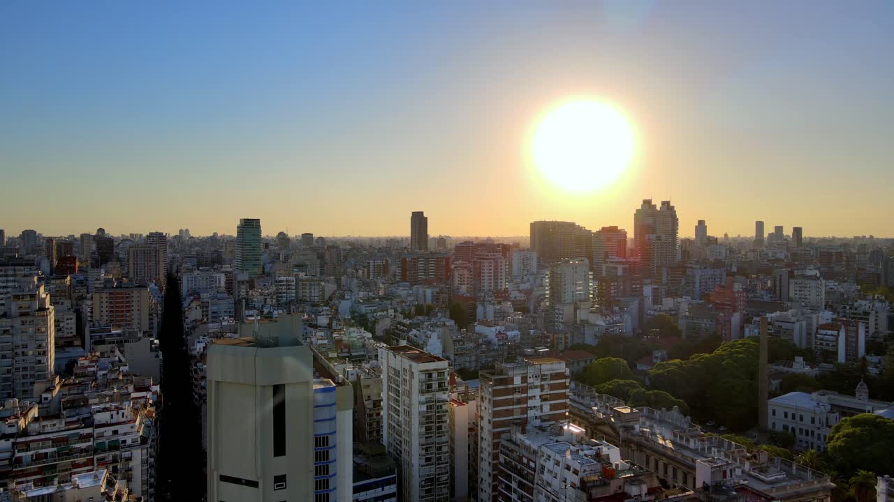 Aerial rising over Recoleta neighborhood buildings and skyscrapers at golden hour, Buenos Aires