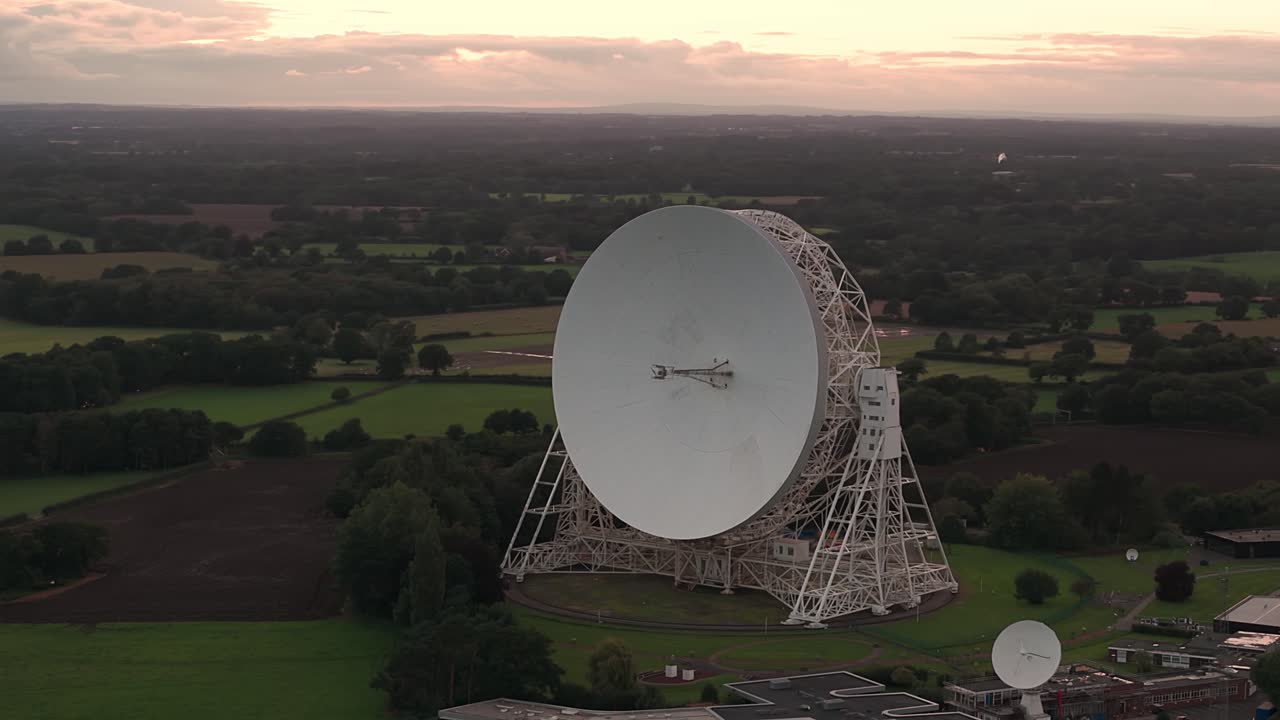 Aerial shot of the Lovell Telescope at Jodrell Bank Observatory surrounded by nature