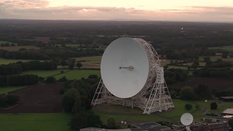 aerial shot of the lovell telescope at jodrell bank observatory surrounded by nature